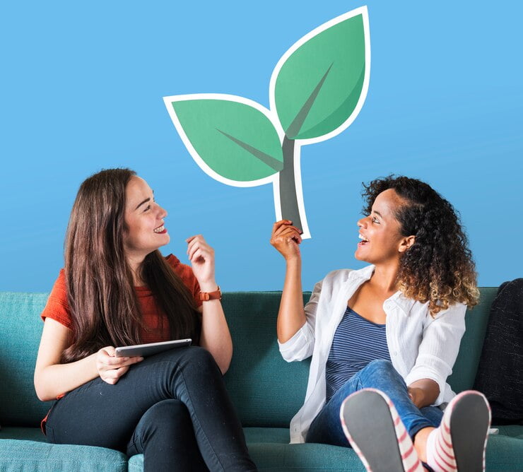 Alegres mulheres segurando um ícone de planta