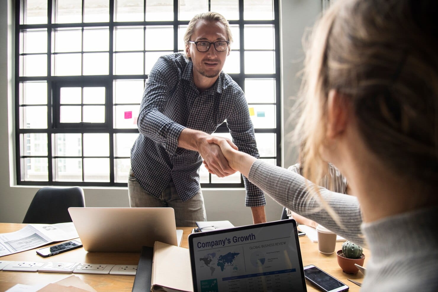 Exemplo 6: alinhamento real entre marketing e vendas Empresários apertando as mãos de acordo
