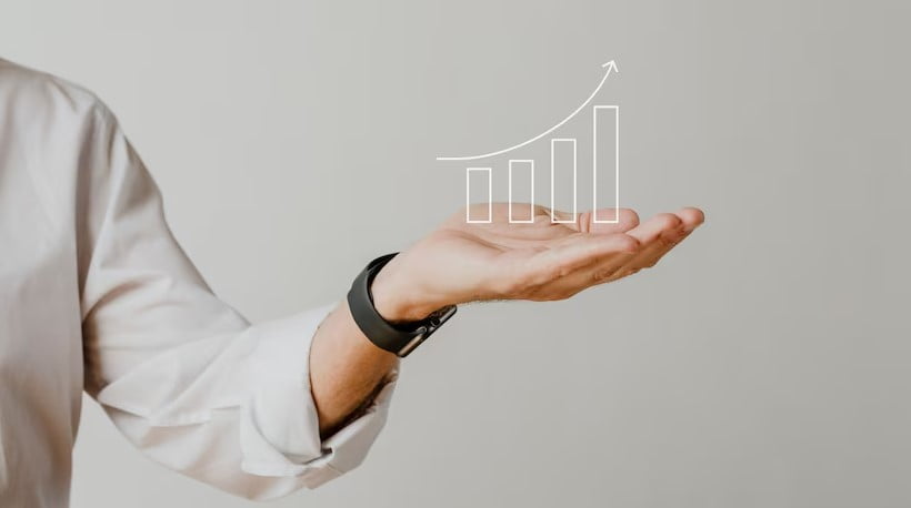 Digital increasing bar graph with businessman hand overlay
