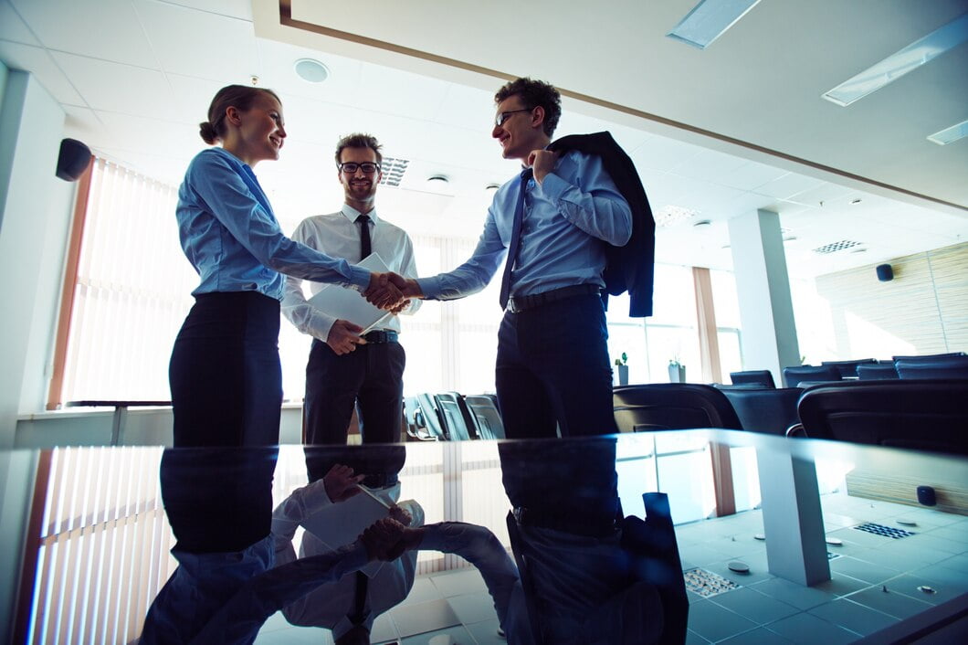 Parcerias estratégicas e colaborações Empresários que agitam as mãos no local de trabalho