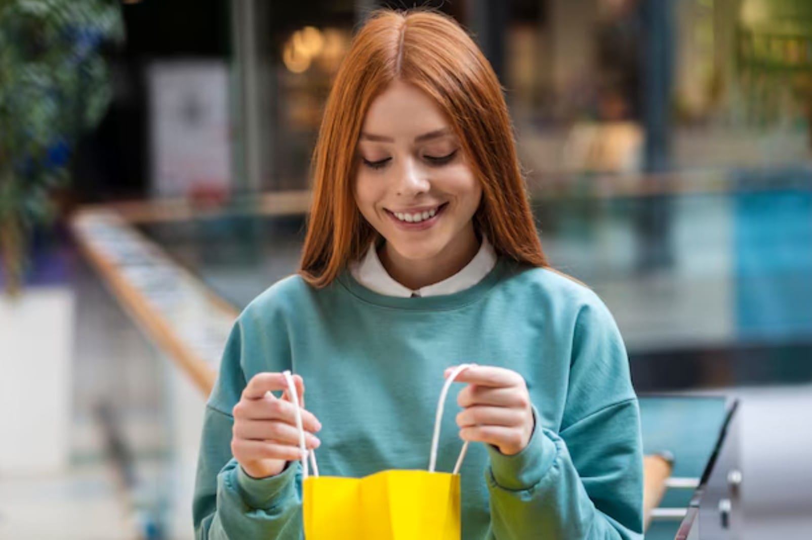 Vista frontal mulher olhando em uma sacola de compras
